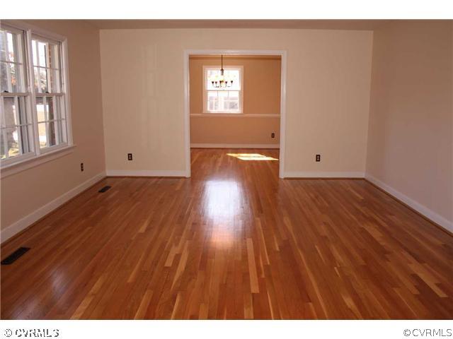 3008 Osborne Road Chester, VA 23831 - Photo 3 of 12 a view of an empty room with wooden floor and a window