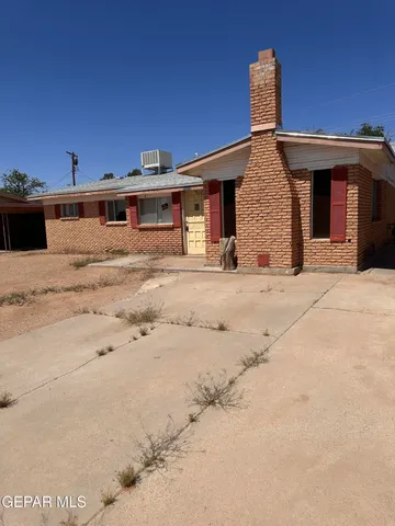 a view of a house with wooden fence