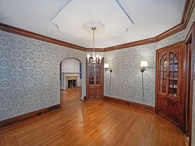 a view of a hallway with wooden floor and entryway