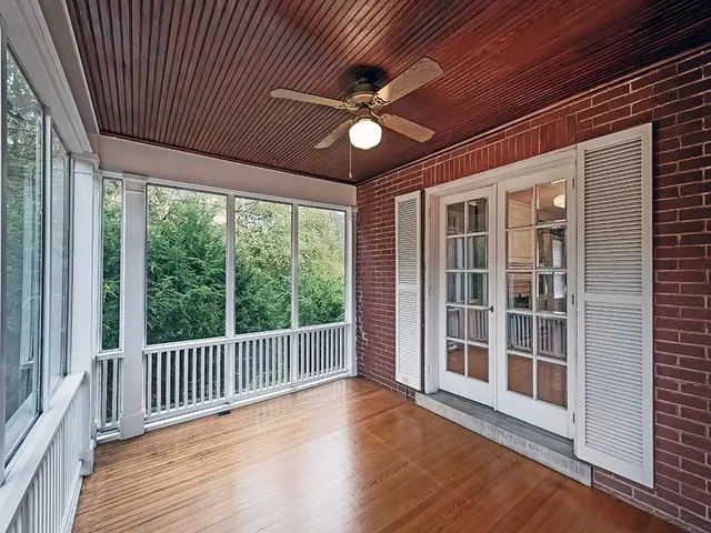 a view of a porch with wooden floor and a ceiling fan