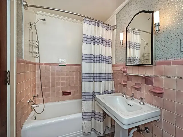 a bathroom with a sink a mirror and a shower