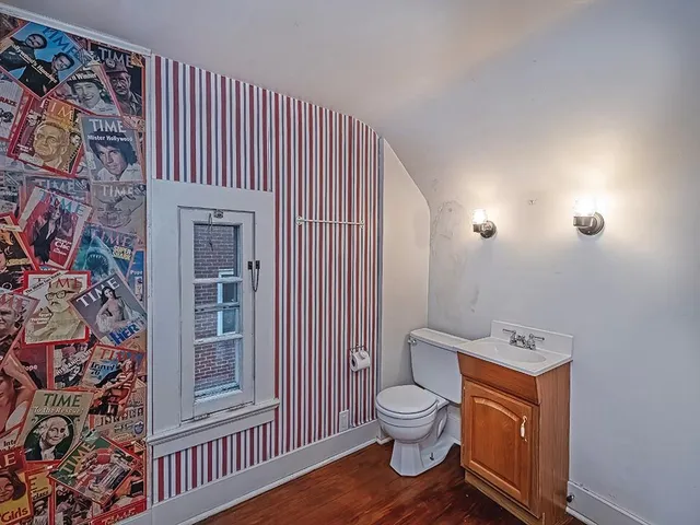 a white toilet sitting next to a bathroom sink