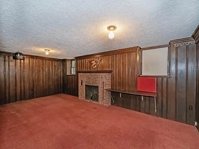 a view of a livingroom with an empty space and a fireplace