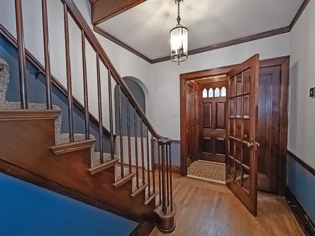 a view of entryway and hall with wooden floor