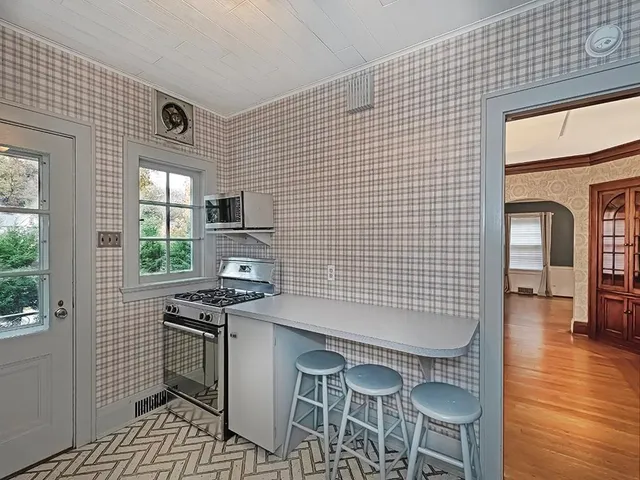 a kitchen with stainless steel appliances a stove a sink and a refrigerator