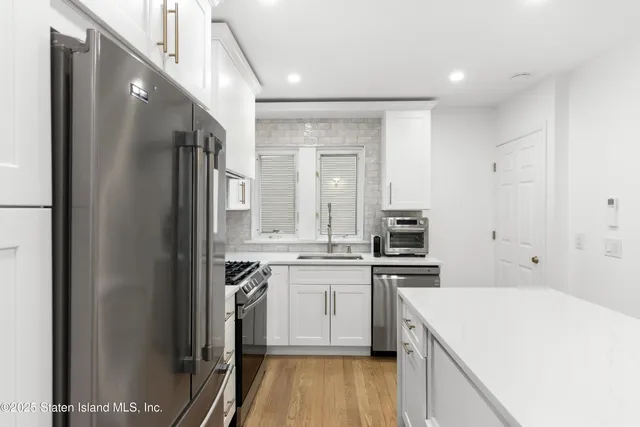 a kitchen with a stove a sink and a refrigerator