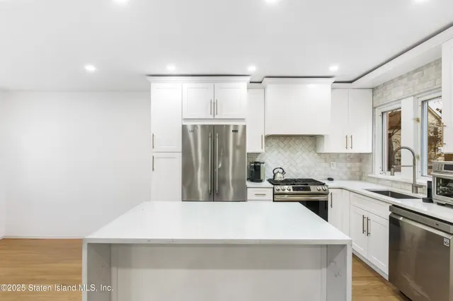 a kitchen with a refrigerator a sink and cabinets