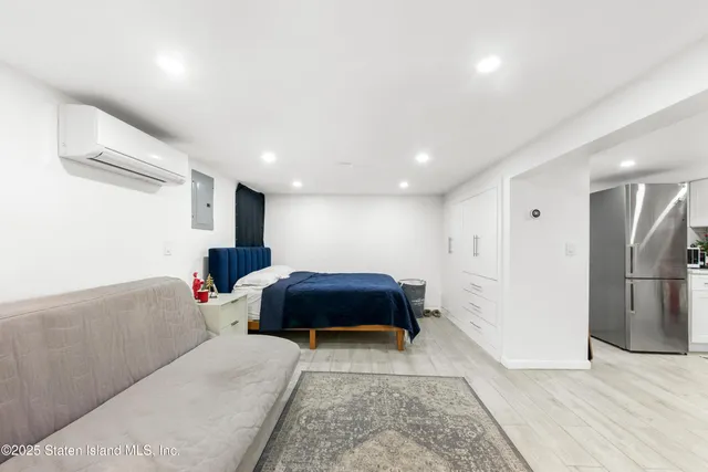 a spacious bedroom with a bed and a couch