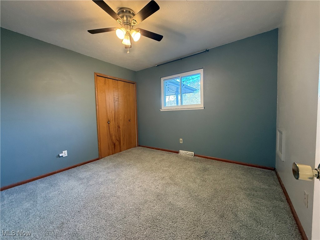 9083 Priem Road Strongsville, OH 44149 - Photo 18 of 28 Unfurnished bedroom featuring baseboards, visible vents, carpet, a closet, and ceiling fan