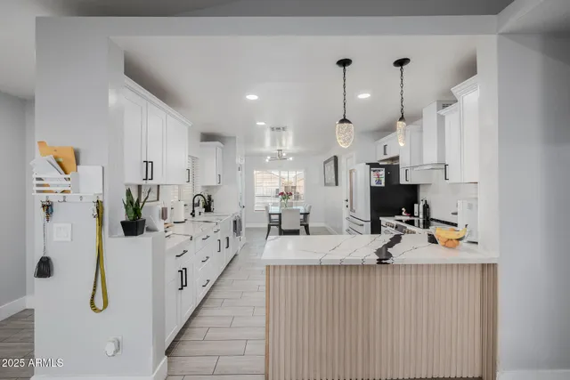 a kitchen with a stove a sink and a refrigerator