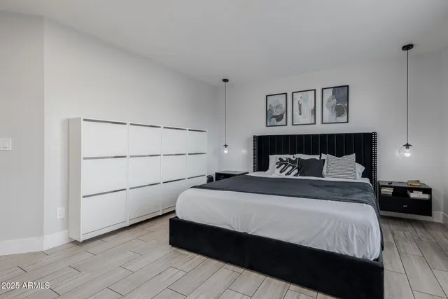 a bedroom with a bed and a chandelier