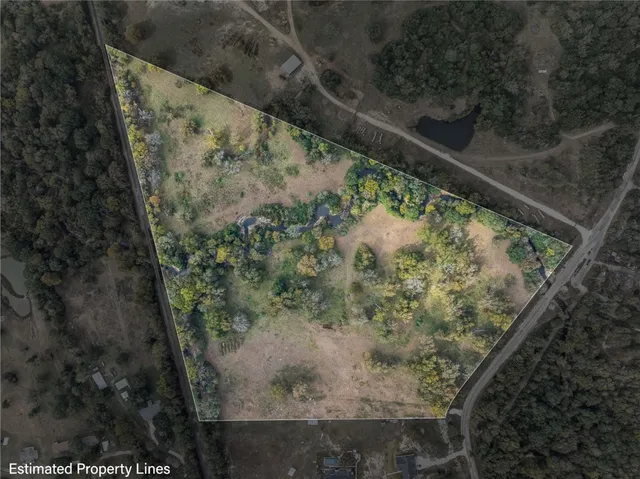 a view of a yard with wooden fence