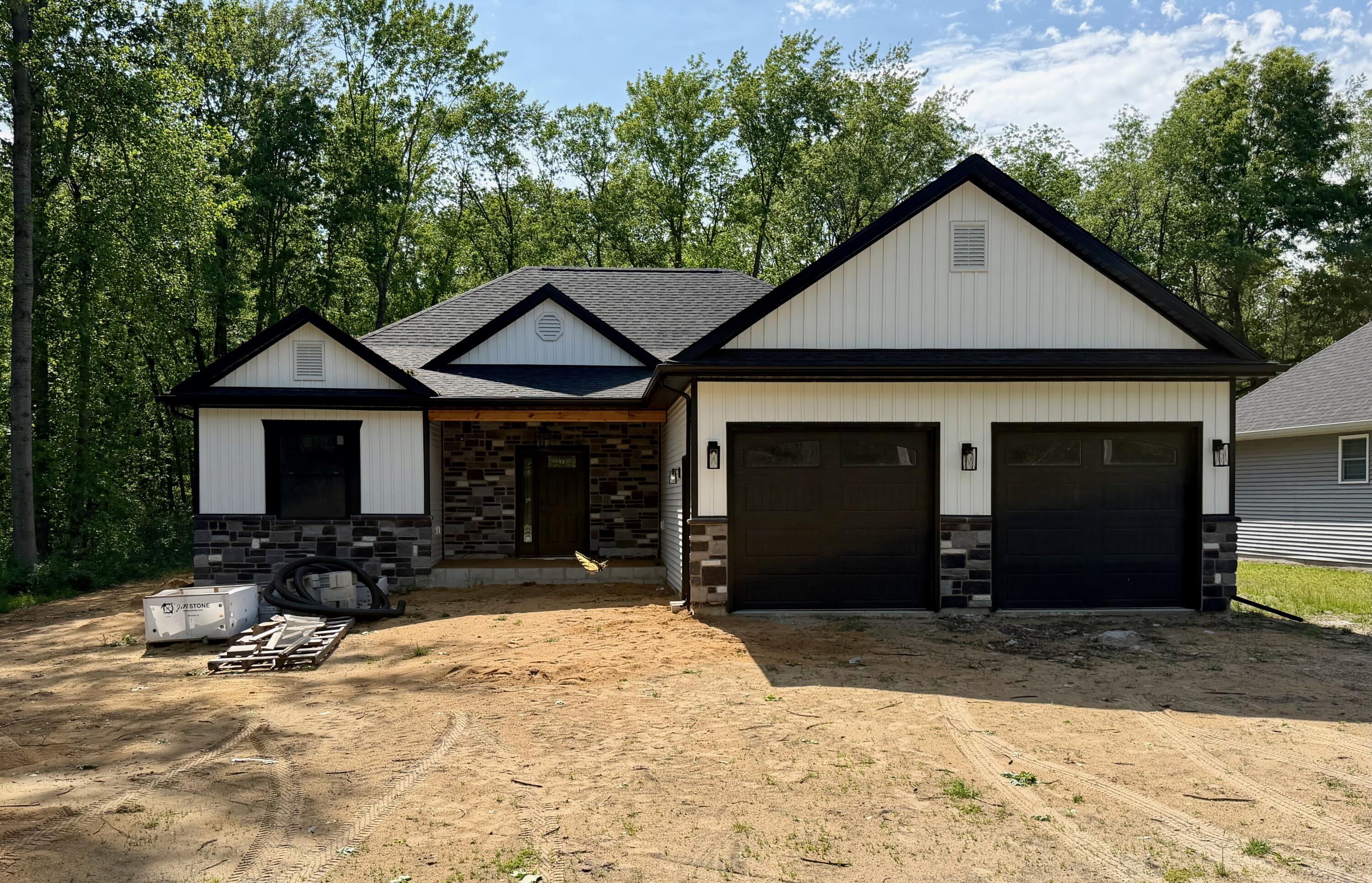 1247 South Roosevelt Road Knox, IN 46534 - Photo 1 of 2 a front view of a house with a yard and garage