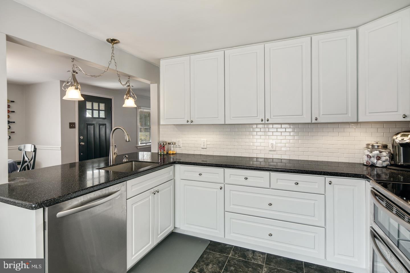 1025 Chesterfield Road Barrington, NJ 08033 - Photo 11 of 32 a kitchen with granite countertop white cabinets and white appliances