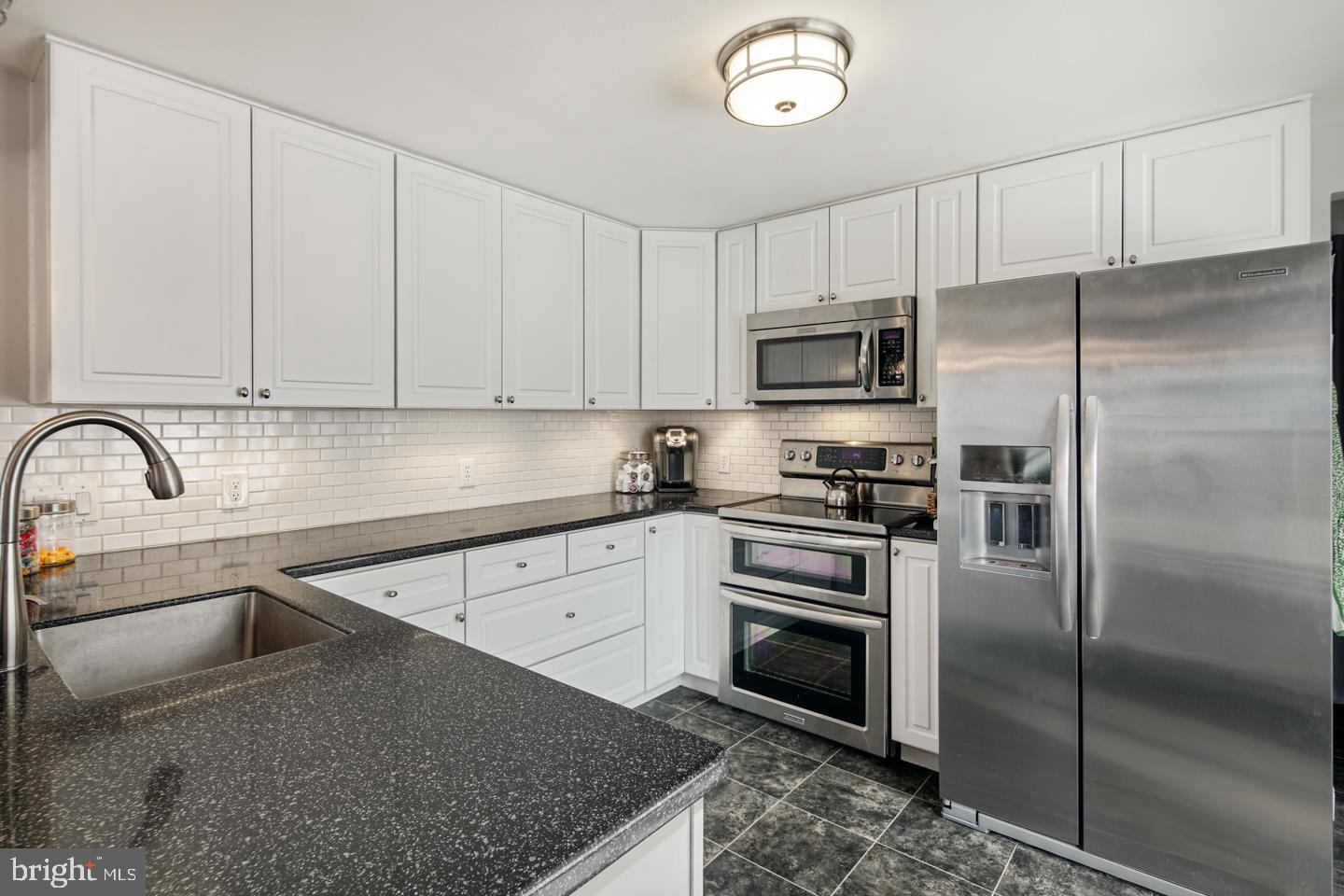 1025 Chesterfield Road Barrington, NJ 08033 - Photo 12 of 32 a kitchen with stainless steel appliances granite countertop a refrigerator sink and cabinets