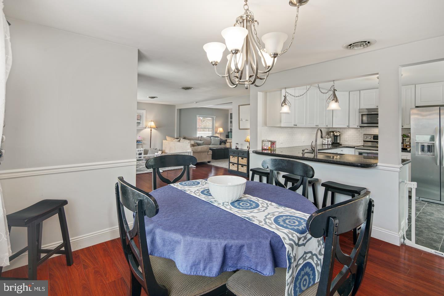 1025 Chesterfield Road Barrington, NJ 08033 - Photo 16 of 32 a view of a dining room with furniture and wooden floor