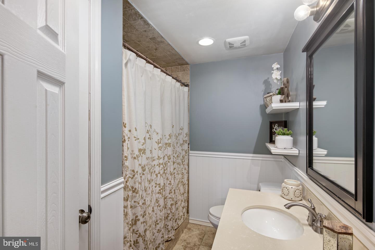 1025 Chesterfield Road Barrington, NJ 08033 - Photo 22 of 32 a white toilet sitting next to a bathroom sink