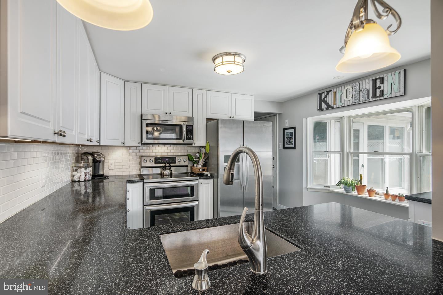1025 Chesterfield Road Barrington, NJ 08033 - Photo 10 of 32 a kitchen with stainless steel appliances granite countertop a refrigerator and a stove top oven