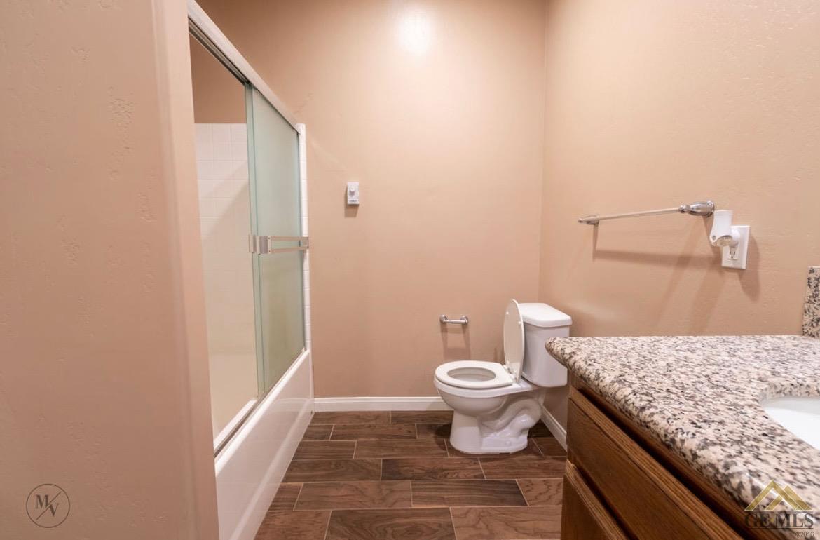 Undisclosed Address Wasco, CA 93280 - Photo 14 of 28 a bathroom with a granite countertop sink toilet and shower