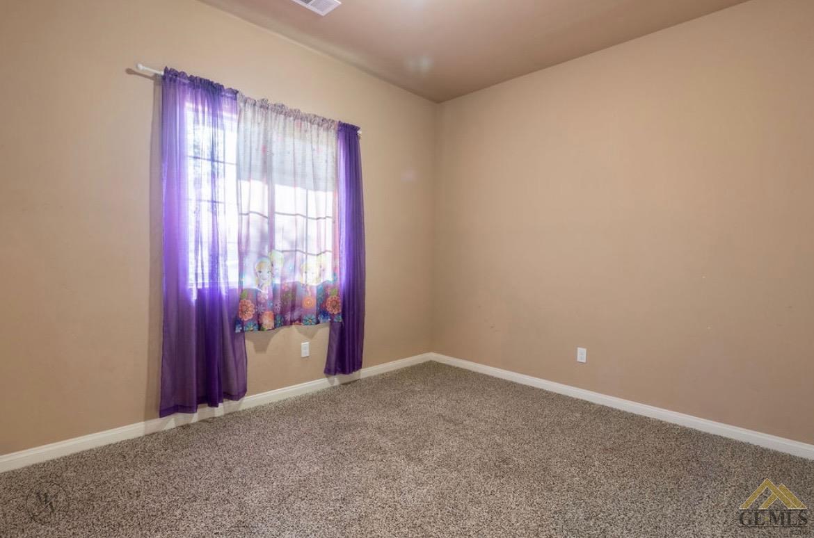 Undisclosed Address Wasco, CA 93280 - Photo 18 of 28 an empty room with windows and closet