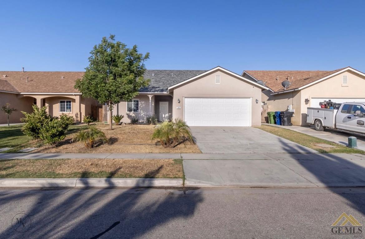 Undisclosed Address Wasco, CA 93280 - Photo 2 of 28 a front view of a house with garden