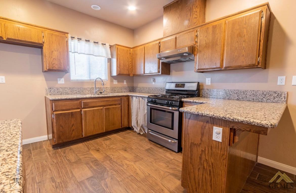Undisclosed Address Wasco, CA 93280 - Photo 4 of 28 a kitchen with stainless steel appliances granite countertop a sink and cabinets