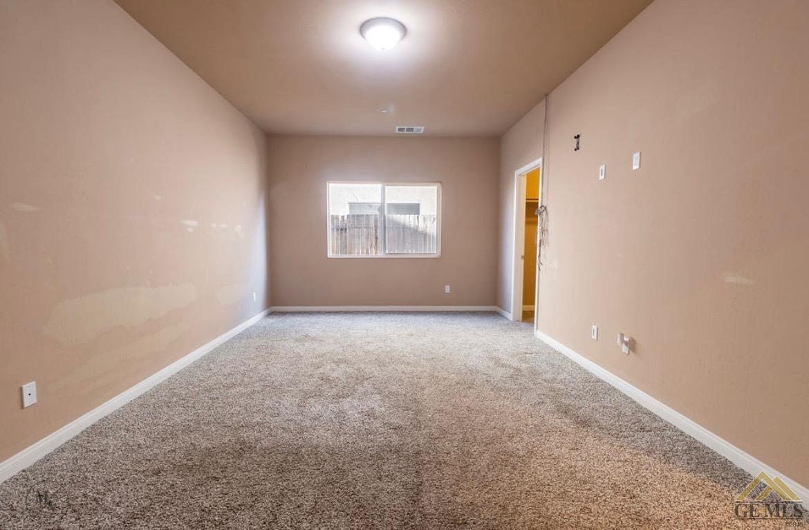 Undisclosed Address Wasco, CA 93280 - Photo 9 of 28 an empty room with a empty space and windows