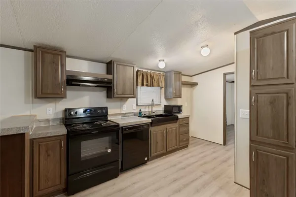 a kitchen with stainless steel appliances a sink stove and refrigerator