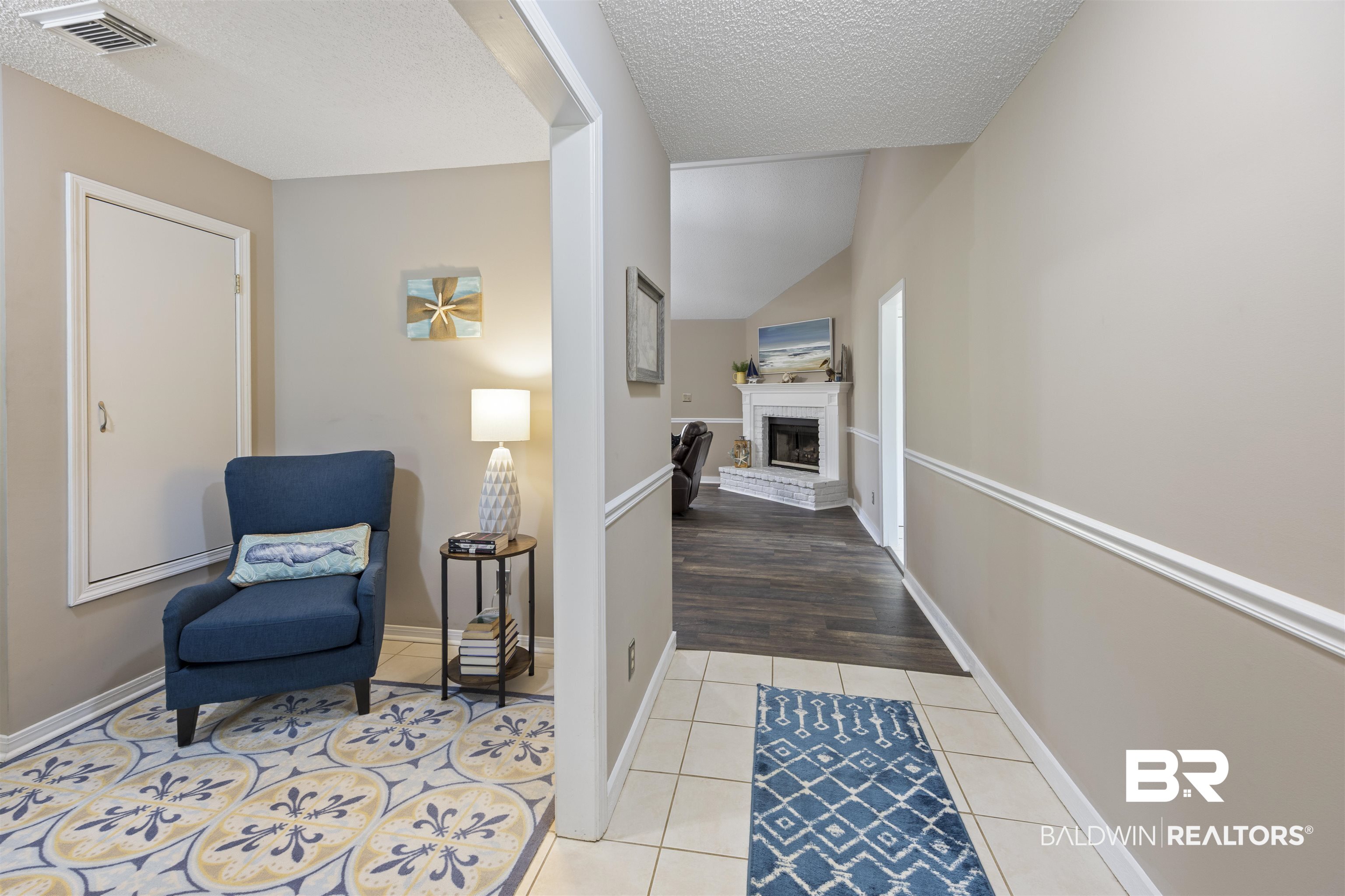 9771 Clarke Ridge Road Foley, AL 36535 - Photo 23 of 72 Corridor with a textured ceiling, baseboards, visible vents, and light tile patterned flooring.