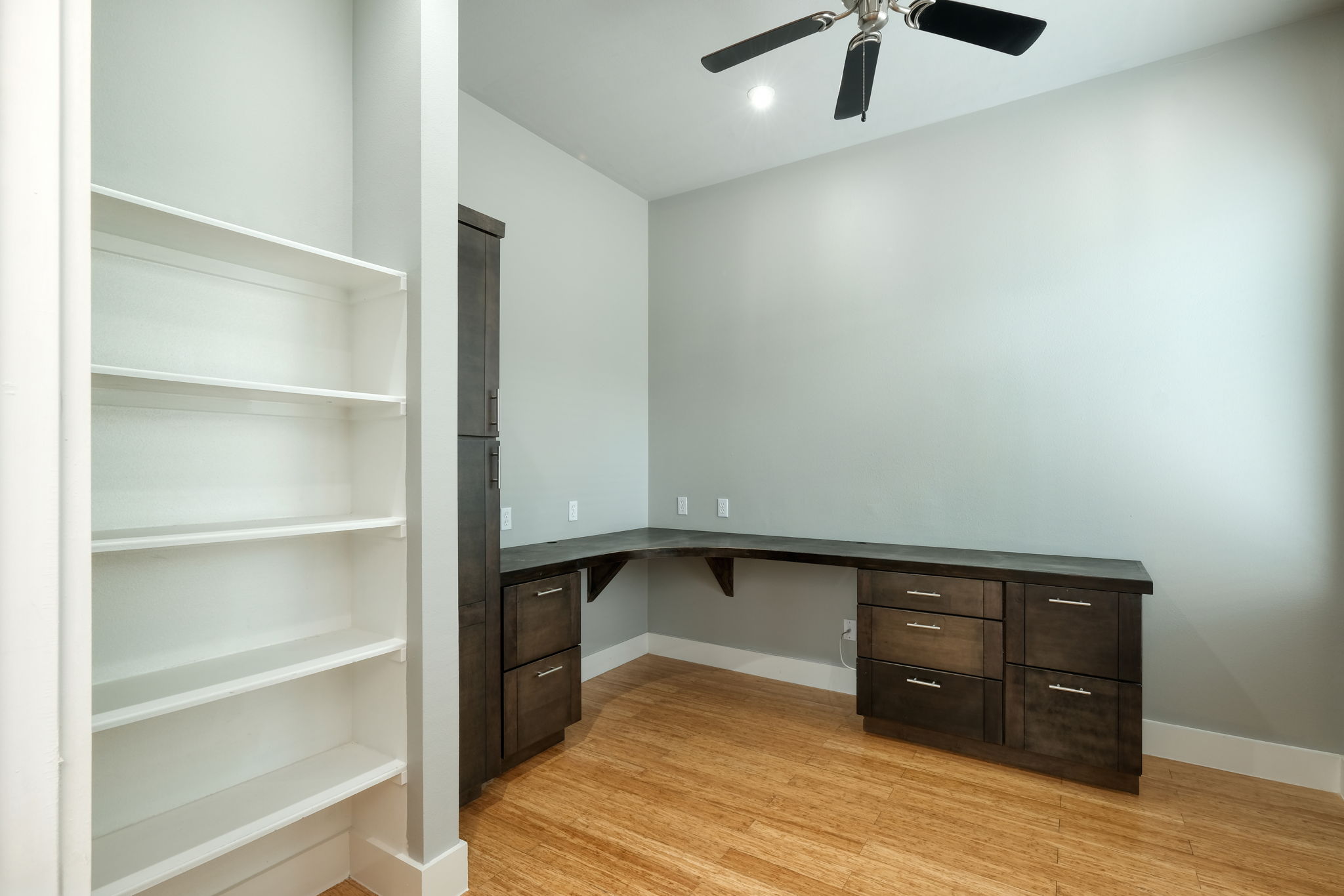 3000 Speedway Street, Unit E Austin, TX 78705 - Photo 5 of 16 Functional built-in desk and shelving create an optimal workspace for productivity.