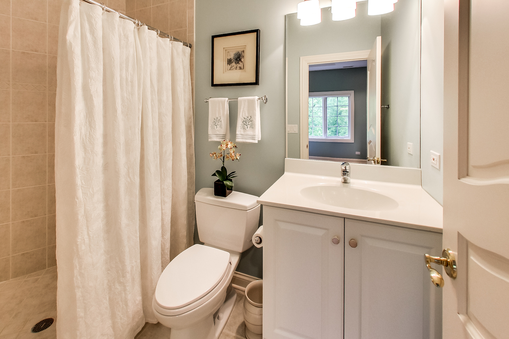 4289 Hilltop Road Long Grove, IL 60047 - Photo 25 of 42 a bathroom with a sink a toilet and shower curtain