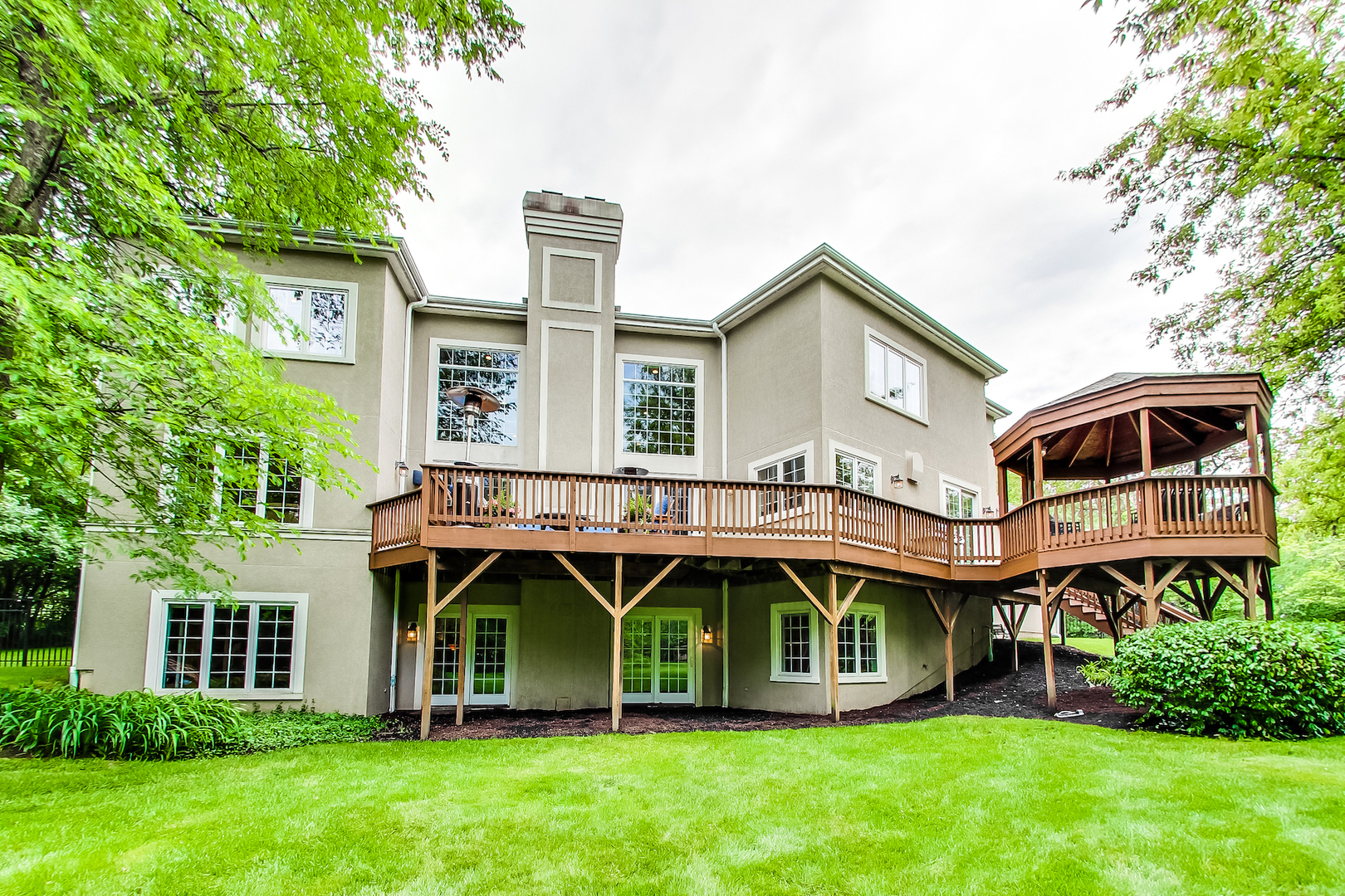 4289 Hilltop Road Long Grove, IL 60047 - Photo 35 of 42 a front view of a house with a garden and plants