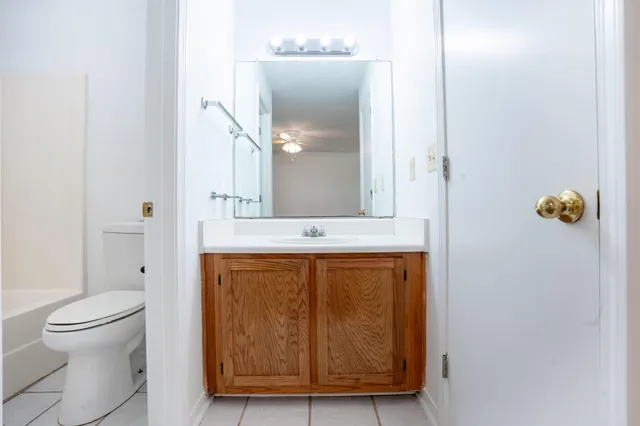 a bathroom with a sink and mirror with toilet