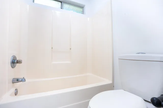 a bathroom with a bathtub and a toilet