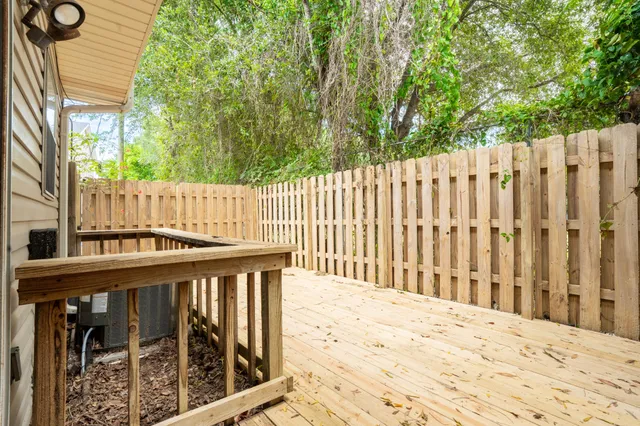 a view of a wooden fence and trees