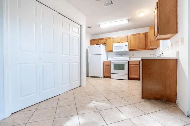 a large kitchen with cabinets and stainless steel appliances
