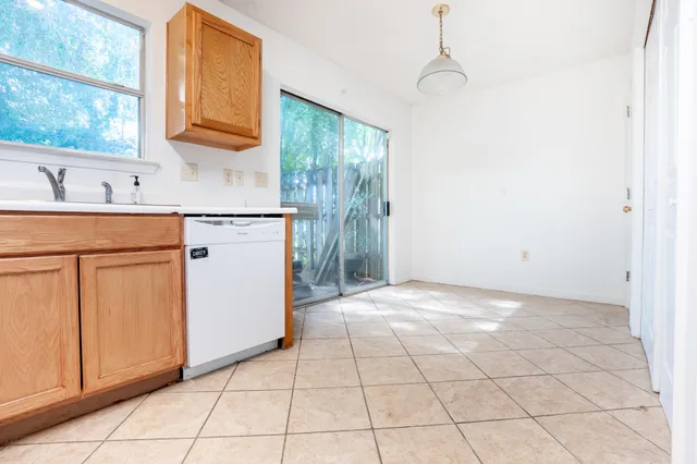 a kitchen with a stove a sink and a refrigerator