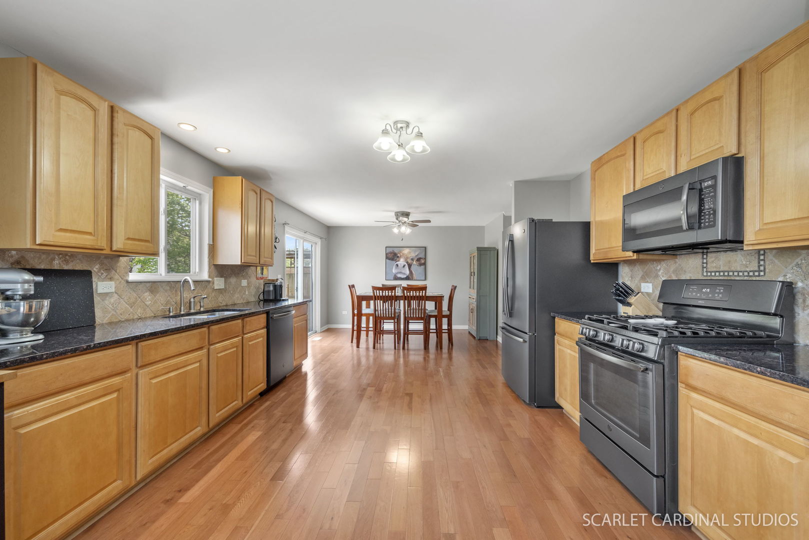 3214 Marbill Farm Road Montgomery, IL 60538 - Photo 2 of 27 a kitchen with stainless steel appliances wooden floors and wooden cabinets