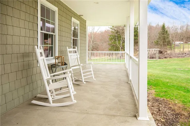 a view of a room with a floor to ceiling window and an outdoor space