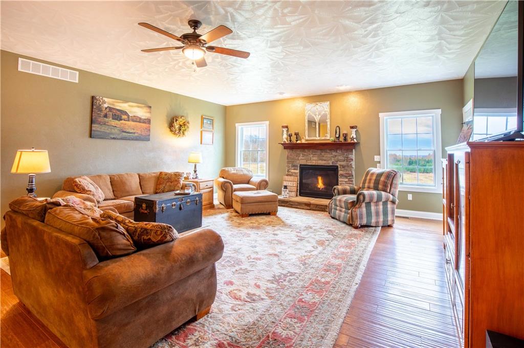 262 Windy Point Road Harrisville, PA 16038 - Photo 19 of 38 a living room with furniture fireplace and a table