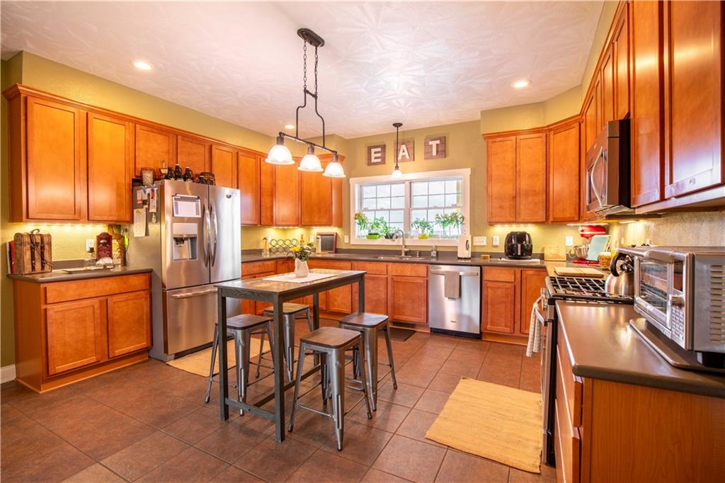 262 Windy Point Road Harrisville, PA 16038 - Photo 21 of 38 a kitchen with stainless steel appliances kitchen island granite countertop a sink and cabinets