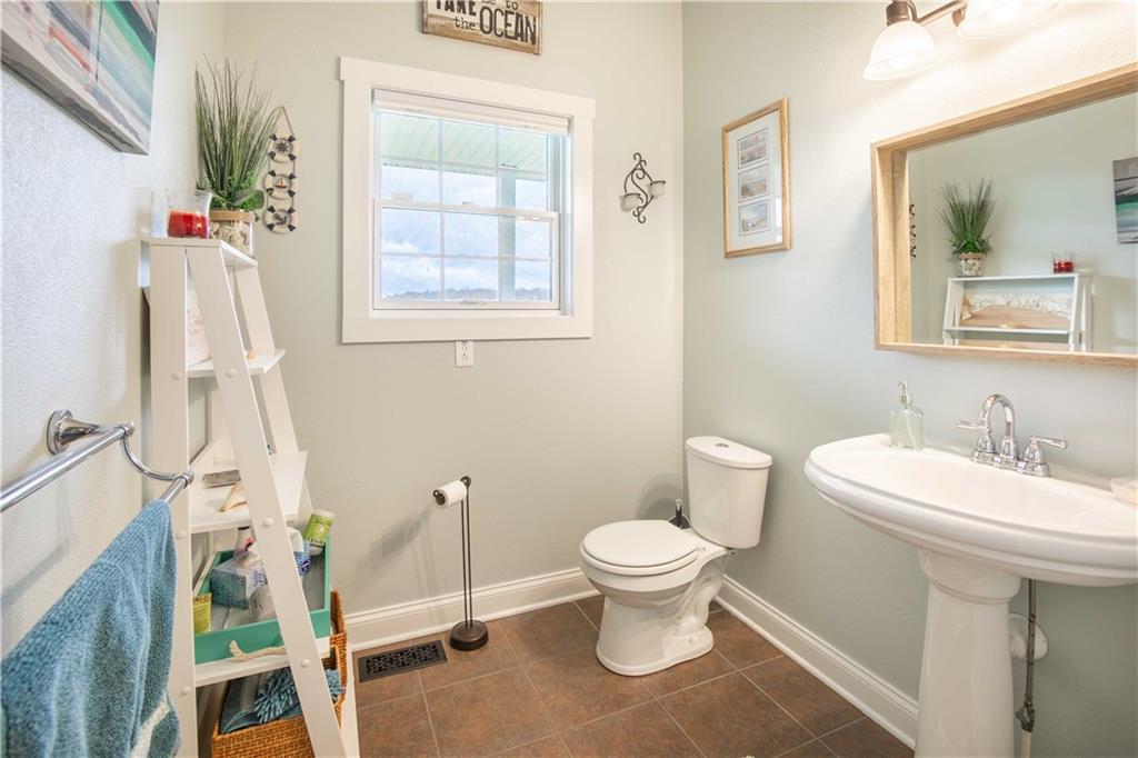 262 Windy Point Road Harrisville, PA 16038 - Photo 24 of 38 a bathroom with a toilet sink and mirror