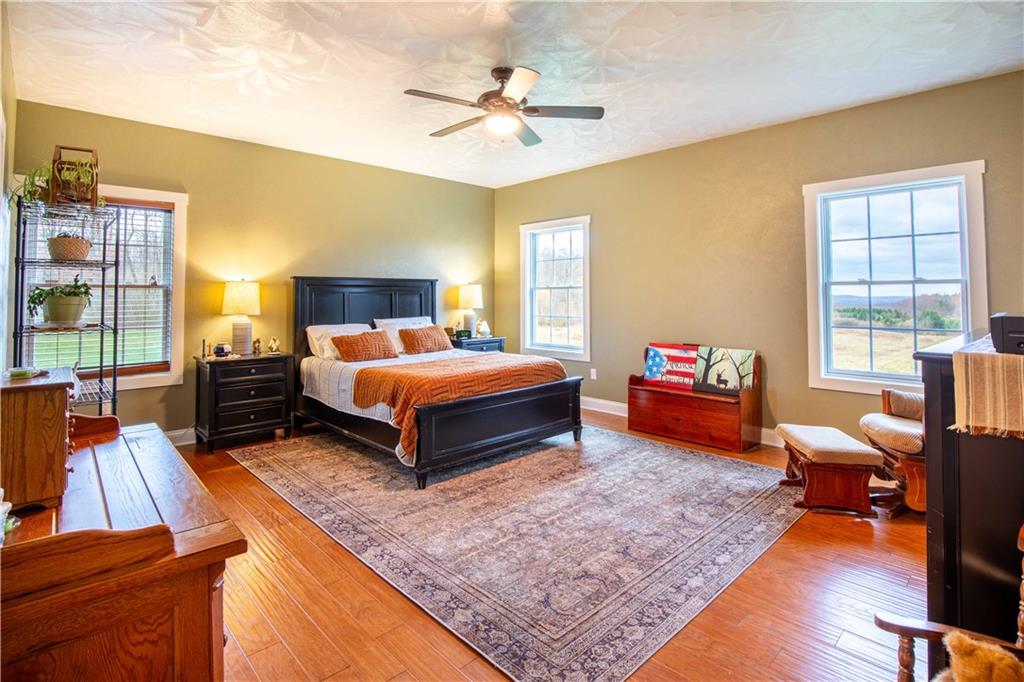 262 Windy Point Road Harrisville, PA 16038 - Photo 25 of 38 a bedroom with a bed and wooden floor