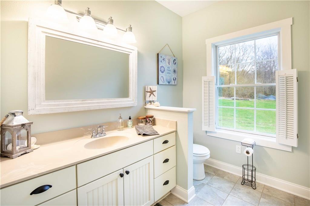 262 Windy Point Road Harrisville, PA 16038 - Photo 27 of 38 a bathroom with a double vanity sink toilet and a mirror
