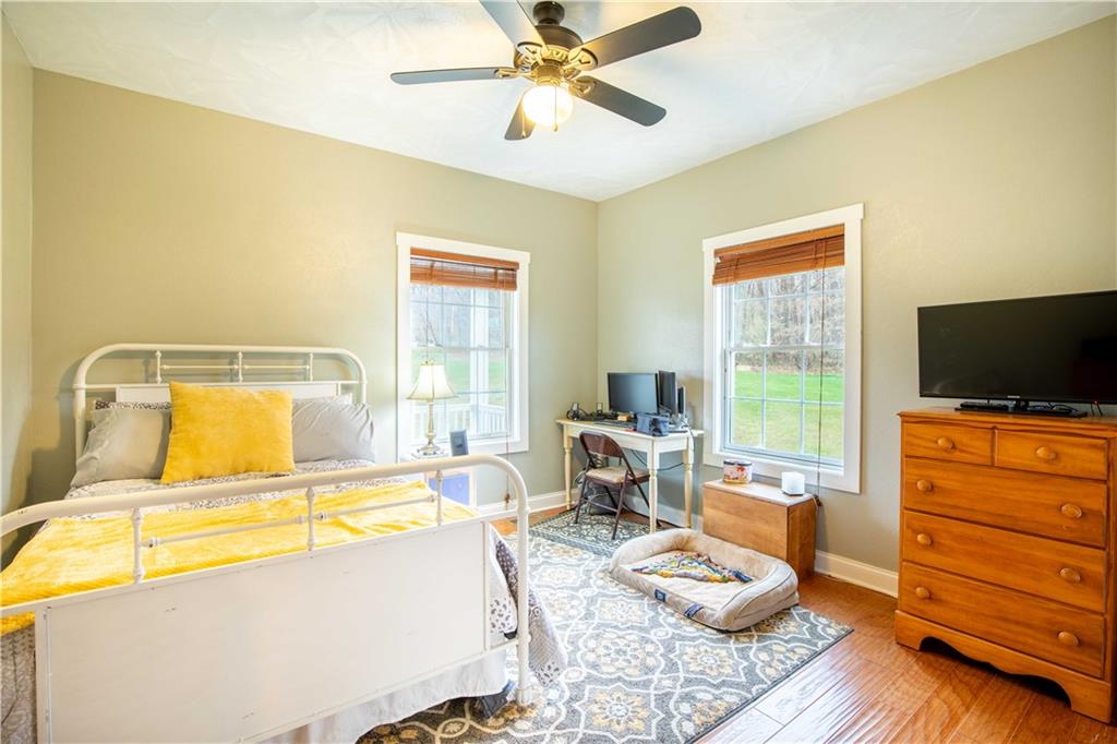 262 Windy Point Road Harrisville, PA 16038 - Photo 29 of 38 a bedroom with a bed and wooden floor