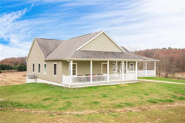 a front view of a house with a yard balcony
