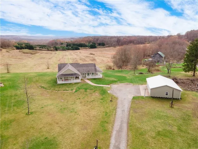 a aerial view of a house with a yard