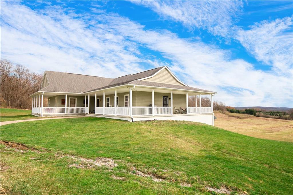 262 Windy Point Road Harrisville, PA 16038 - Photo 7 of 38 a front view of a house with a garden