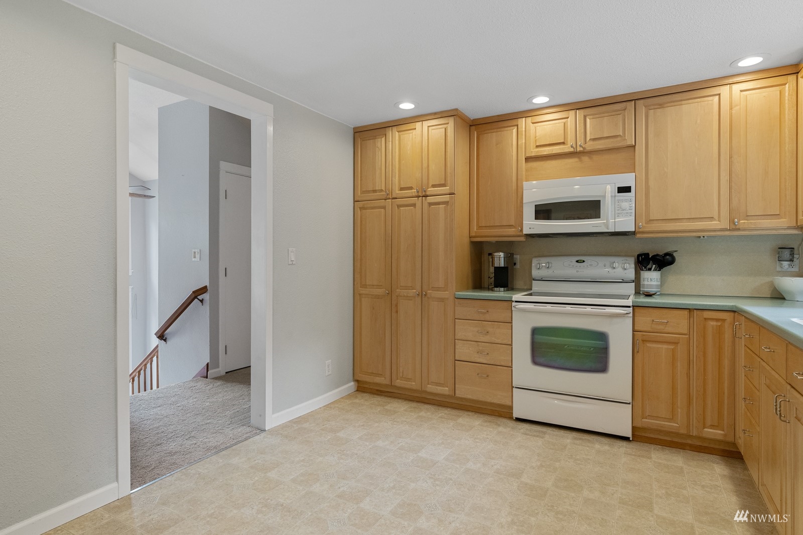 9651 Northeast 201st Street Bothell, WA 98011 - Photo 13 of 39 a kitchen with stainless steel appliances white cabinets and a refrigerator