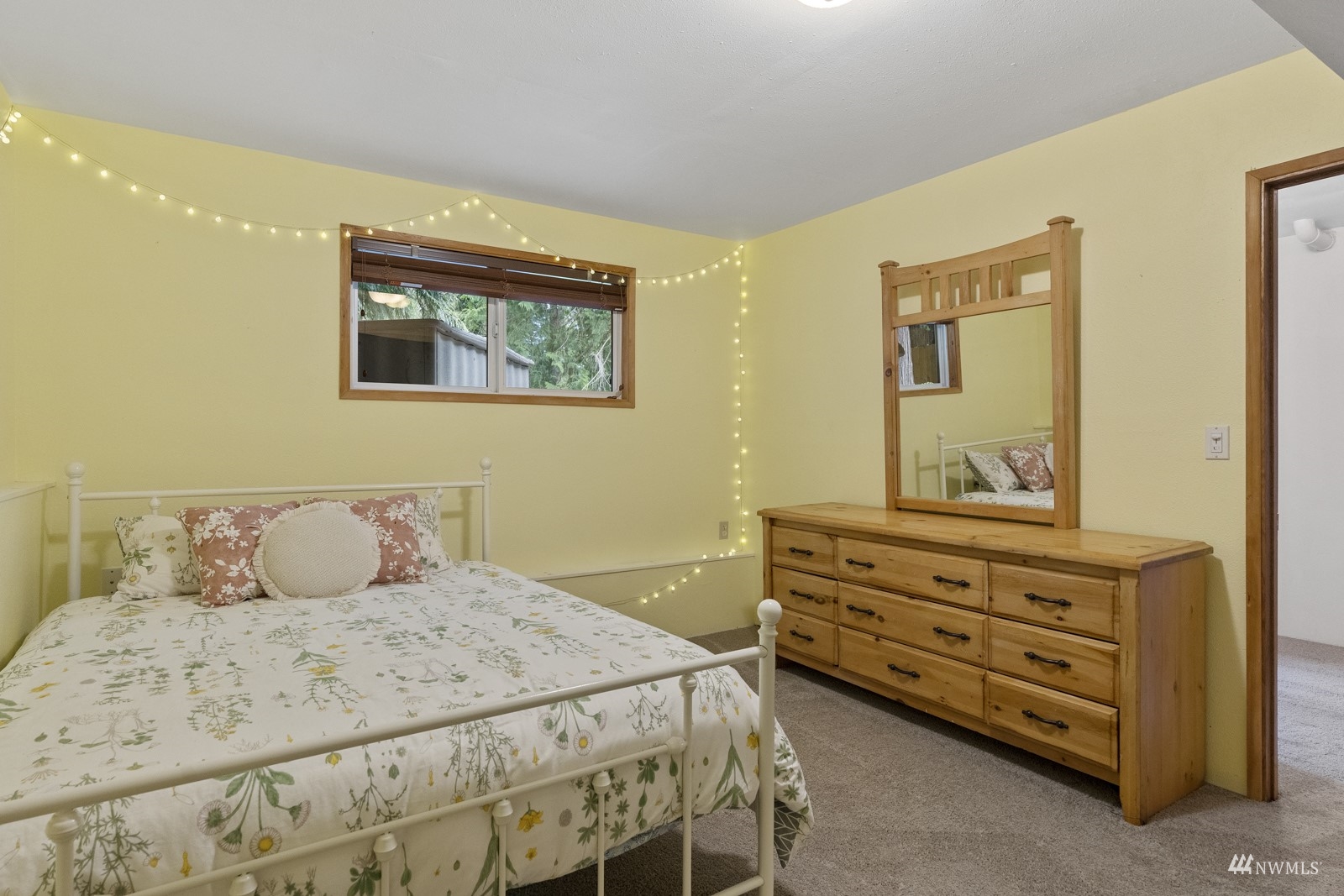 9651 Northeast 201st Street Bothell, WA 98011 - Photo 23 of 39 a bedroom with a bed and a dresser